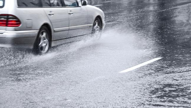 car driving in flooded streets