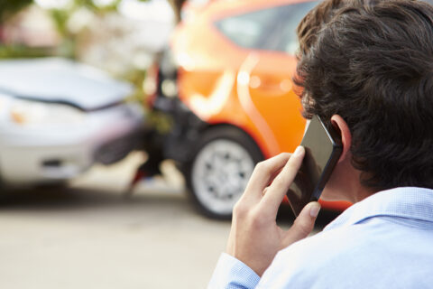 Teenage Driver Making Phone Call After Traffic Accident